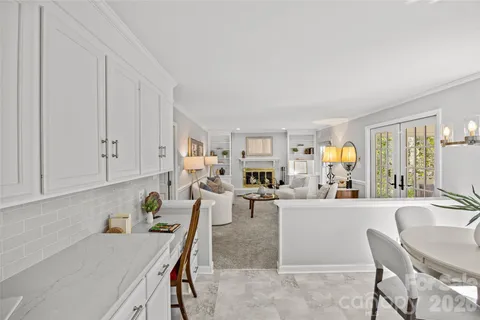 a living room with furniture and a kitchen