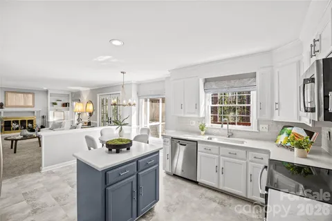 a kitchen with a sink stove and cabinets