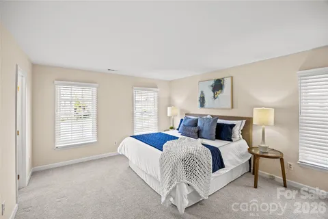 a bedroom with a bed lamp and a window