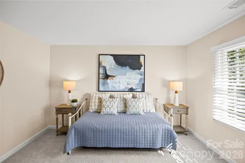 a bedroom with a bed and window