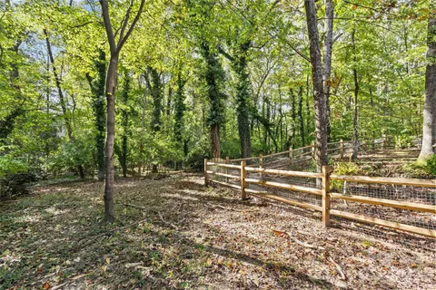 a view of a wooden fence and trees