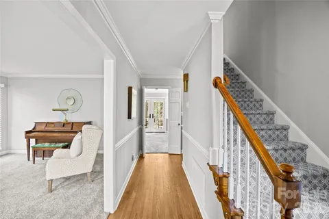 a view of hallway with wooden floor and stairs