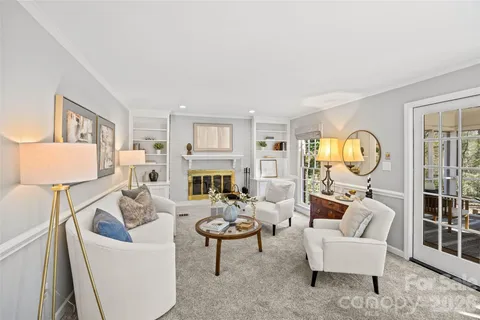 a living room with furniture fireplace and a table