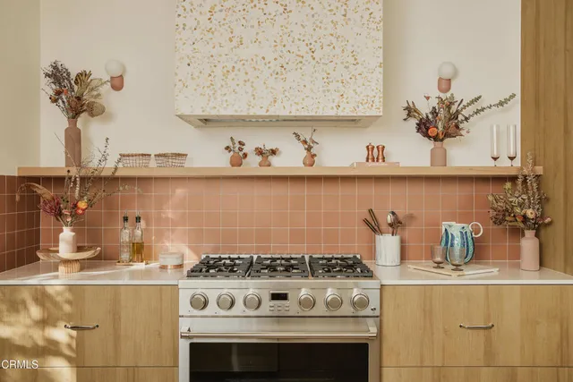 a stove top oven sitting inside of a kitchen