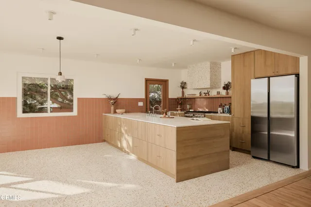 a kitchen with stainless steel appliances granite countertop a refrigerator a sink a stove a microwave a counter top space and cabinets