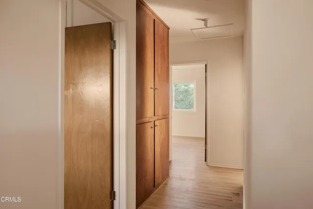a view of hallway with wooden floor