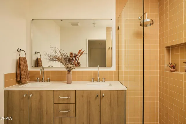 a bathroom with a double vanity sink and a mirror