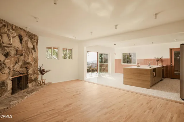a view of a living room kitchen and a wooden floor