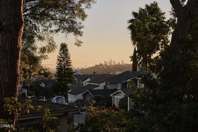 a view of a house with a backyard space and garden