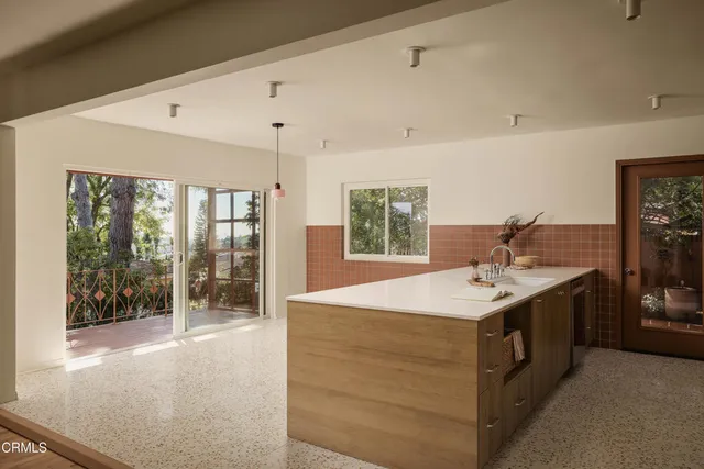 a kitchen with a sink and large window