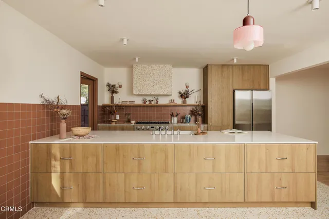 a large kitchen with kitchen island granite countertop a sink cabinets and stainless steel appliances