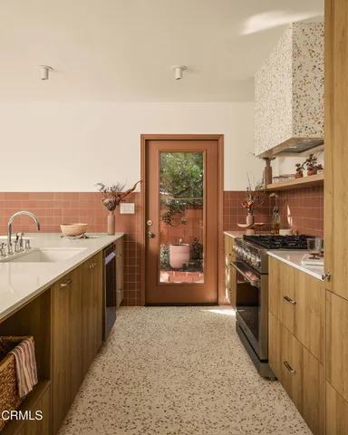 a kitchen with stainless steel appliances granite countertop a refrigerator and a stove top oven