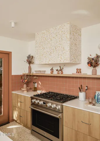 a kitchen with granite countertop a stove and a sink