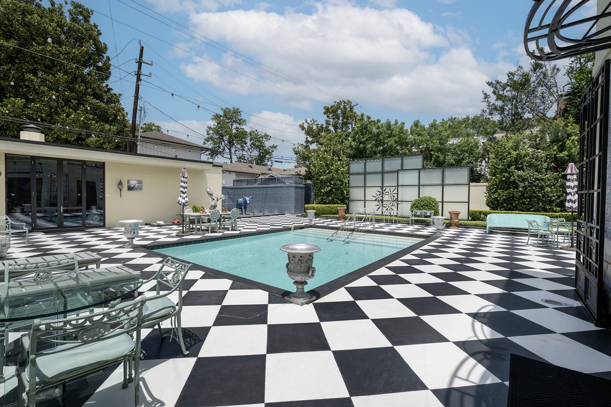 1814 Larchmont Road Houston, TX 77019 - Photo 26 of 29 a view of a swimming pool with a table and chairs