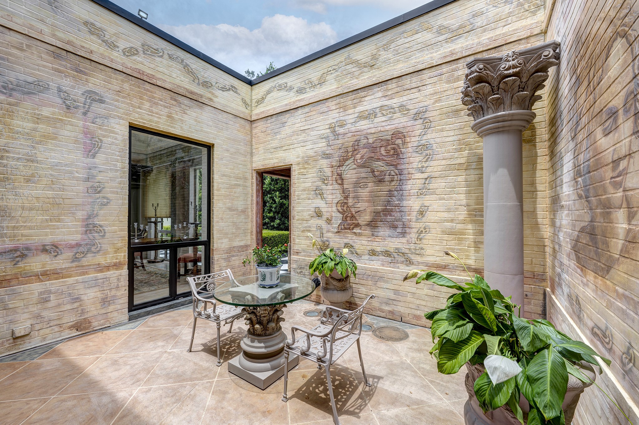 1814 Larchmont Road Houston, TX 77019 - Photo 10 of 29 a view of a patio with couple of chairs and a potted plant