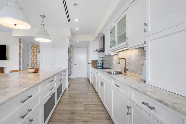 a kitchen with stainless steel appliances a white stove top oven and a wooden floors