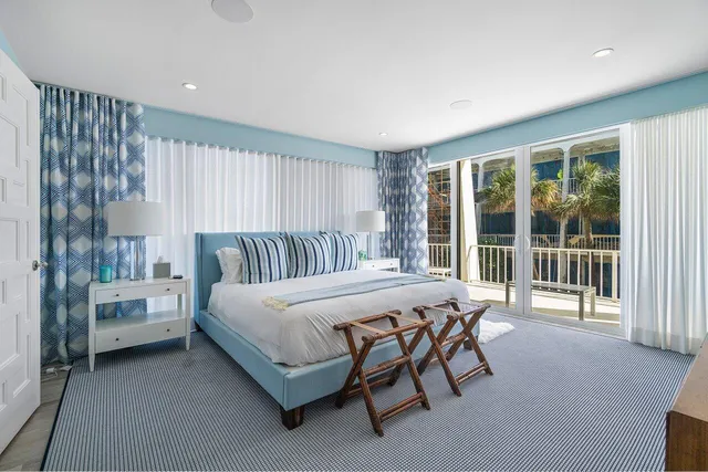 a bedroom with a bed and a flat tv screen on the dresser