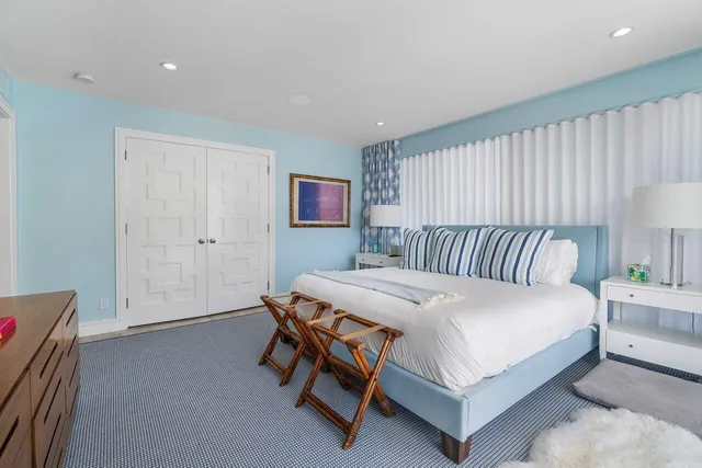 a bathroom with a toilet a sink a vanity and mirror