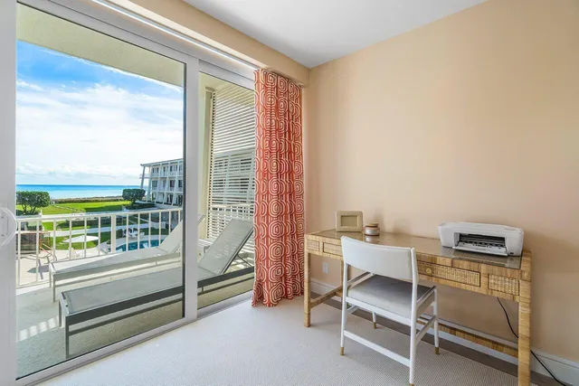 a view of a balcony with a large window and wooden floor