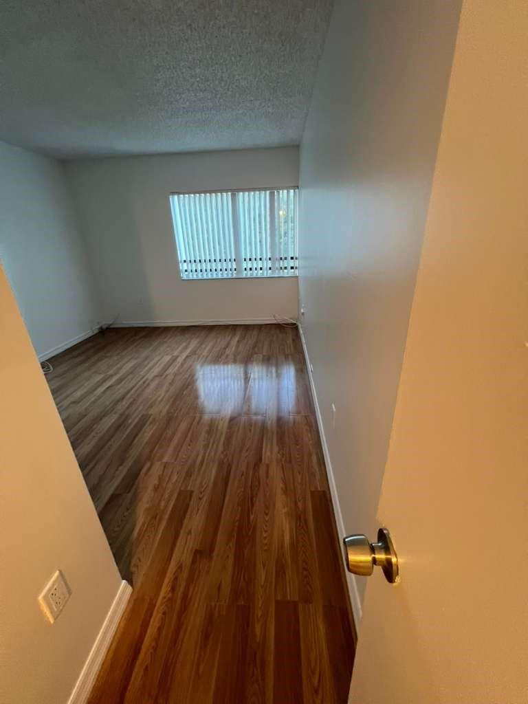 Undisclosed Address Plantation, FL 33324 - Photo 14 of 16 an empty room with wooden floor and windows