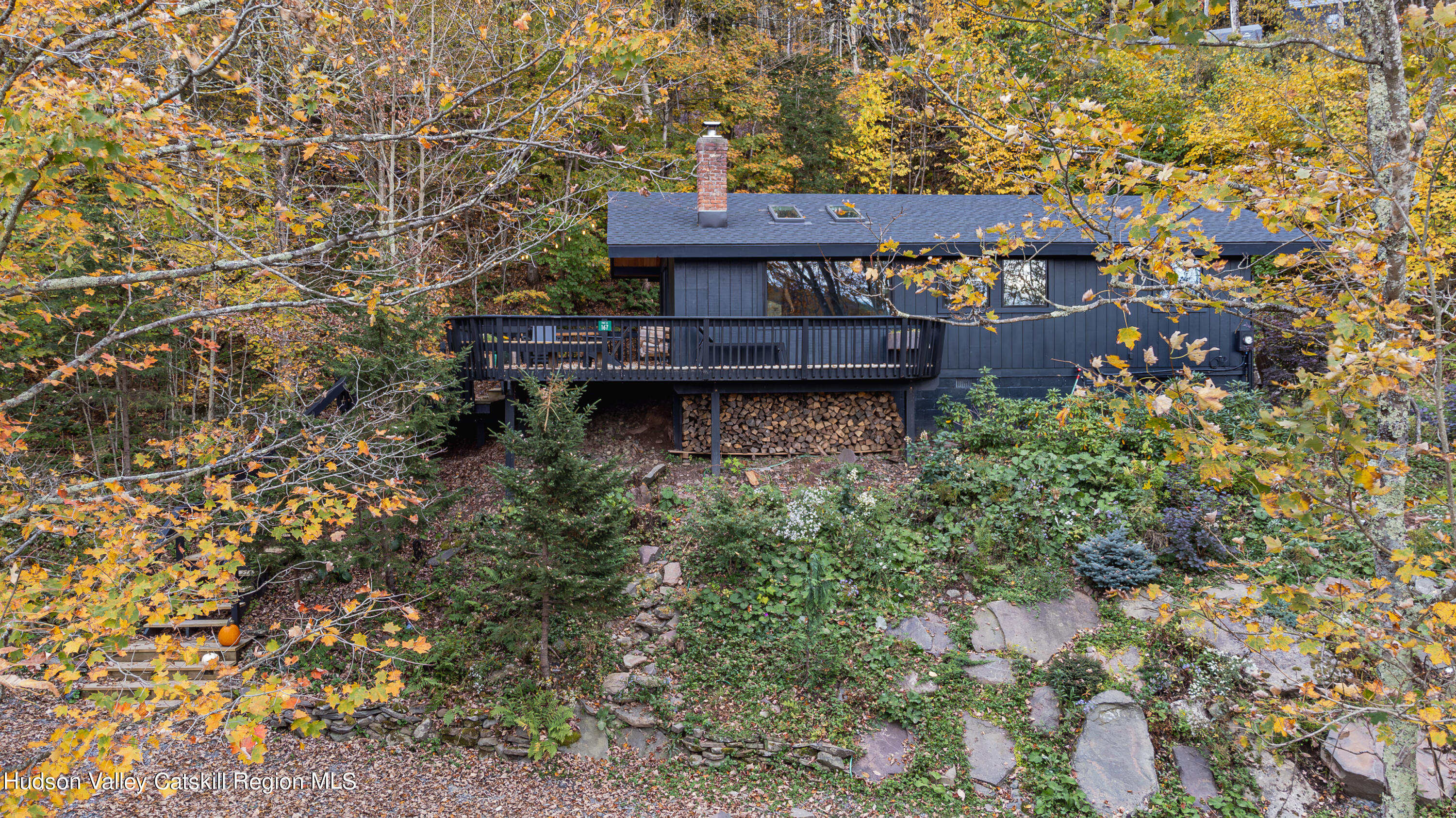 167 Pine Lane Hunter, NY 12442 - Photo 1 of 27 a view of a backyard with plants and a lake view