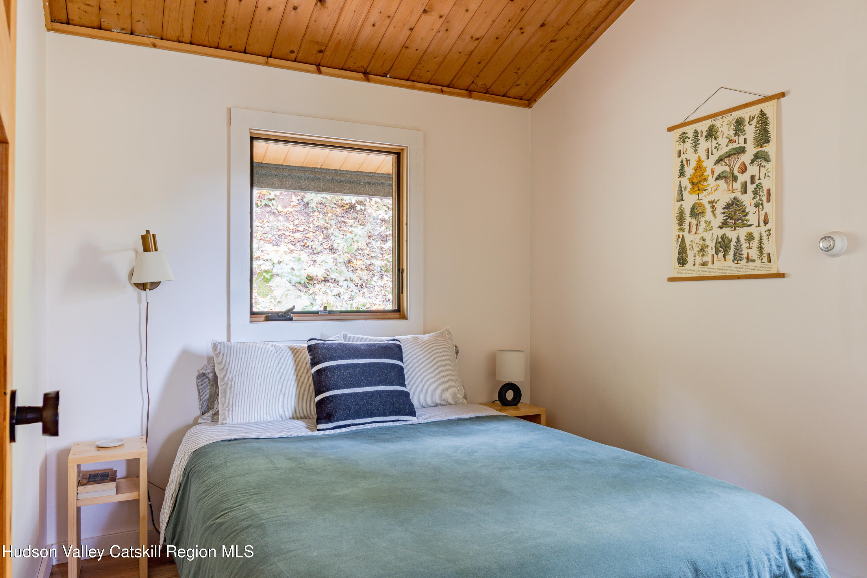 167 Pine Lane Hunter, NY 12442 - Photo 25 of 27 a bedroom with a bed and a painting on the wall