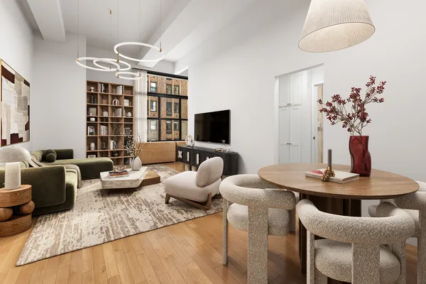 a living room with furniture potted plant and a flat screen tv