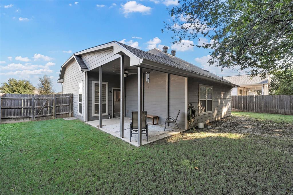 1214 Merganser Way Waco, TX 76706 - Photo 12 of 14 a view of a house with wooden fence and a large tree