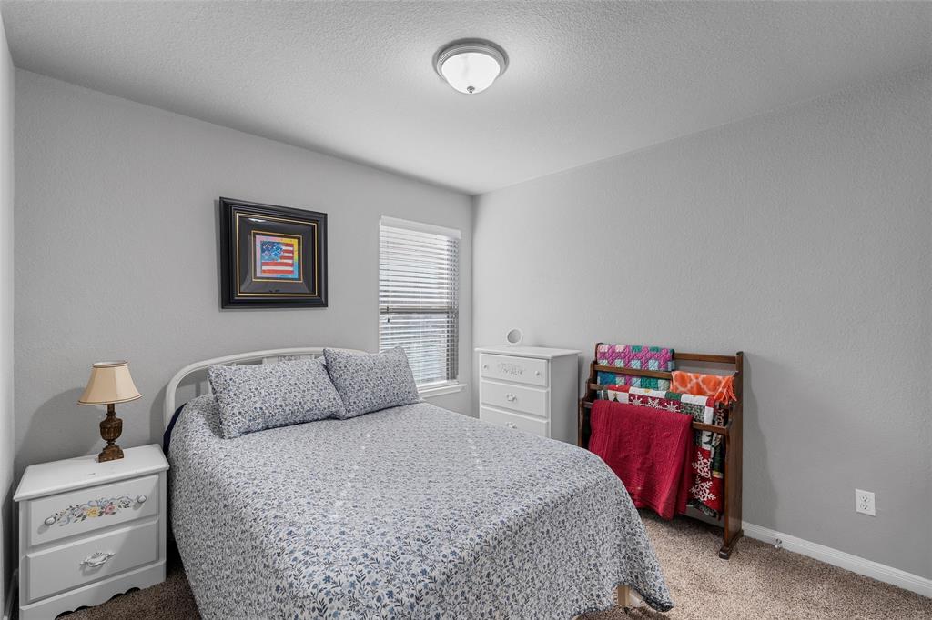 1214 Merganser Way Waco, TX 76706 - Photo 9 of 14 a bedroom with a bed and wooden floor