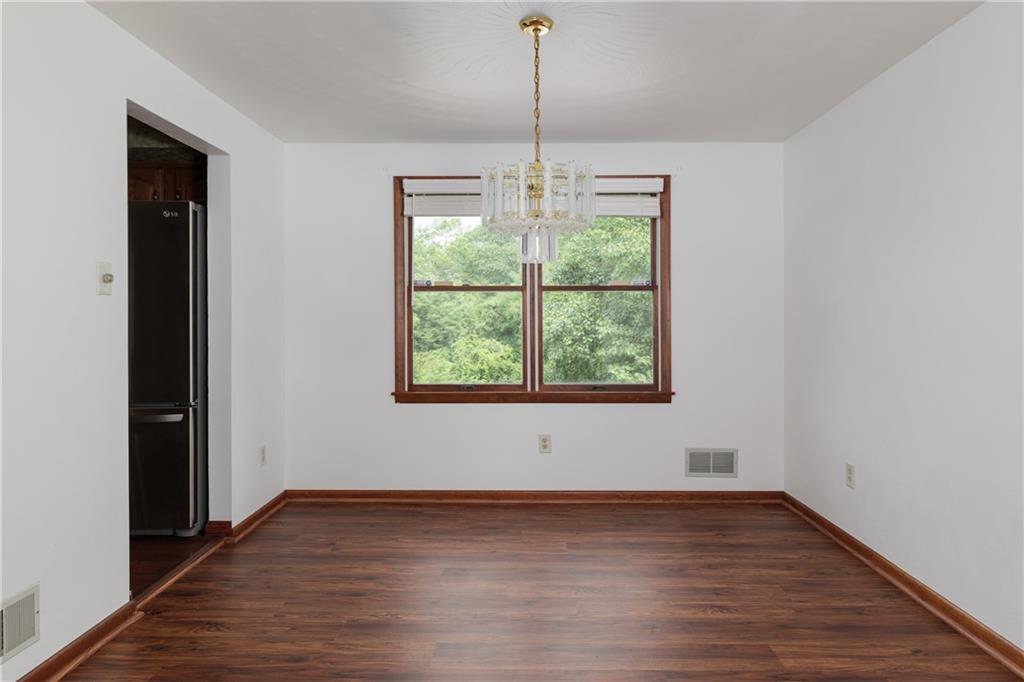 118 Klein Road Clairton, PA 15025 - Photo 11 of 39 an empty room with wooden floor and windows