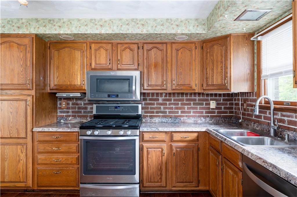 118 Klein Road Clairton, PA 15025 - Photo 12 of 39 a kitchen with granite countertop a stove and a sink