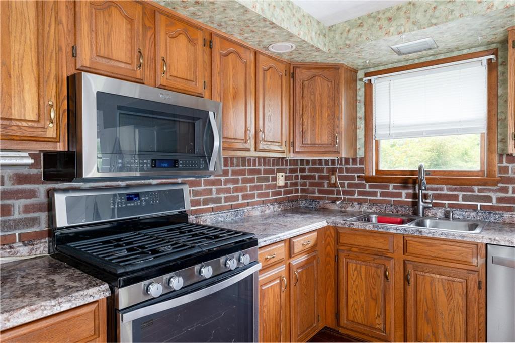 118 Klein Road Clairton, PA 15025 - Photo 14 of 39 a kitchen with granite countertop a stove sink and microwave