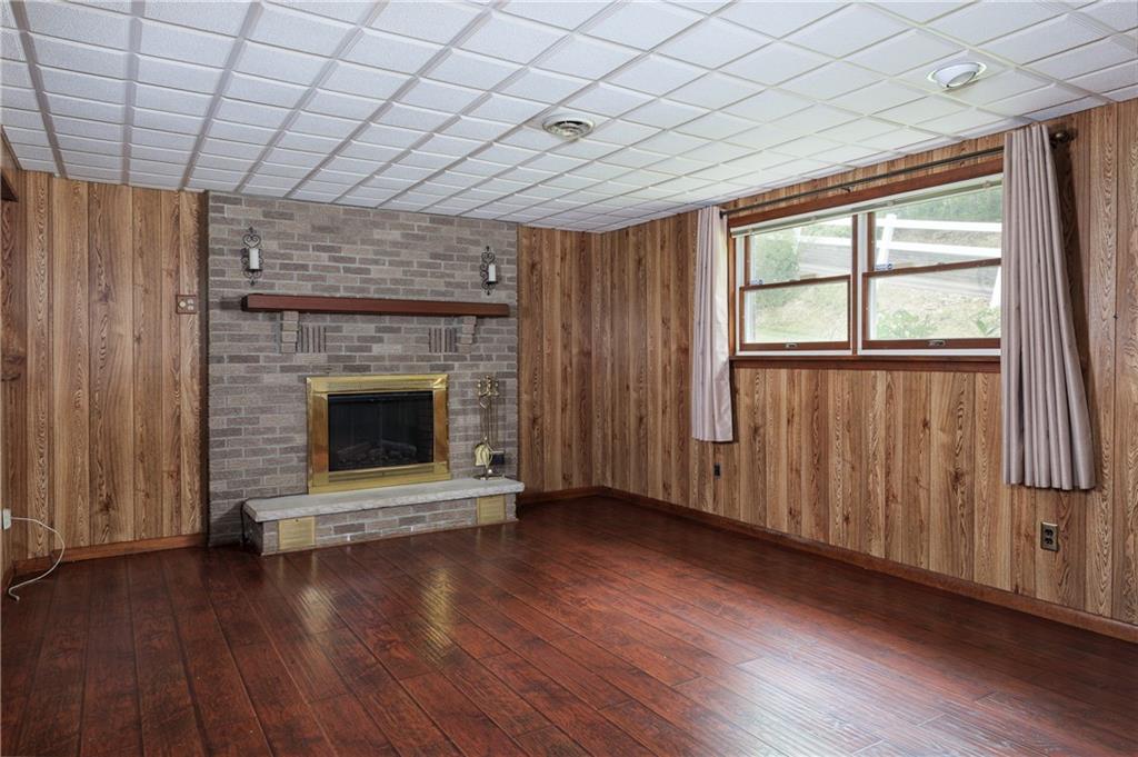 118 Klein Road Clairton, PA 15025 - Photo 25 of 39 an empty room with wooden floor fireplace and windows