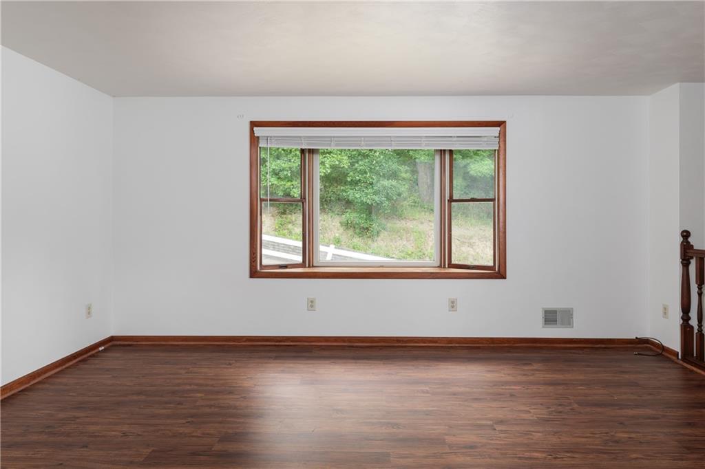 118 Klein Road Clairton, PA 15025 - Photo 9 of 39 a view of an empty room with wooden floor and a window