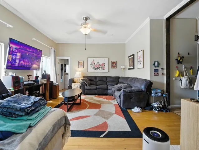 a living room with lots of furniture and kitchen view