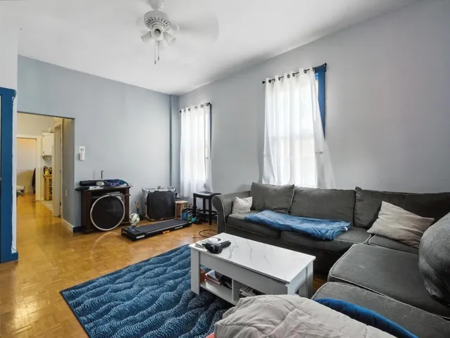 a kitchen with refrigerator cabinets and wooden floor
