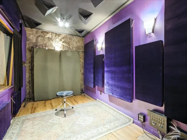 a kitchen with a refrigerator a table chairs and a refrigerator