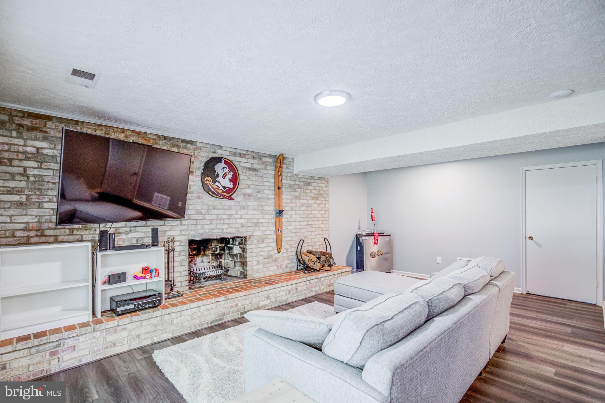 7307 Reservation Drive Springfield, VA 22153 - Photo 37 of 47 Lower level family room with fireplace