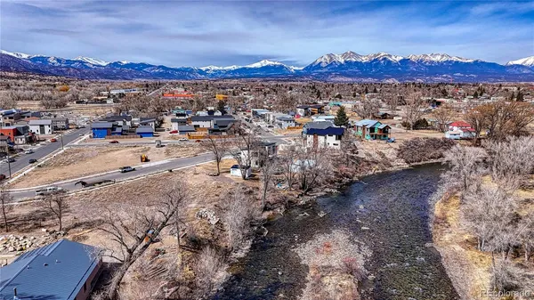 a view of a yard with a tree in the background