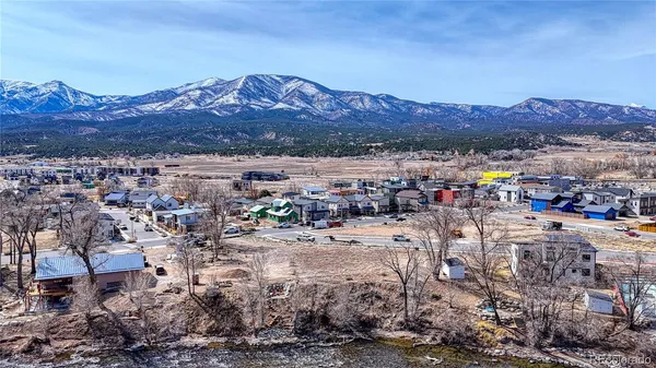 a view of a city with lots of car parked on the road