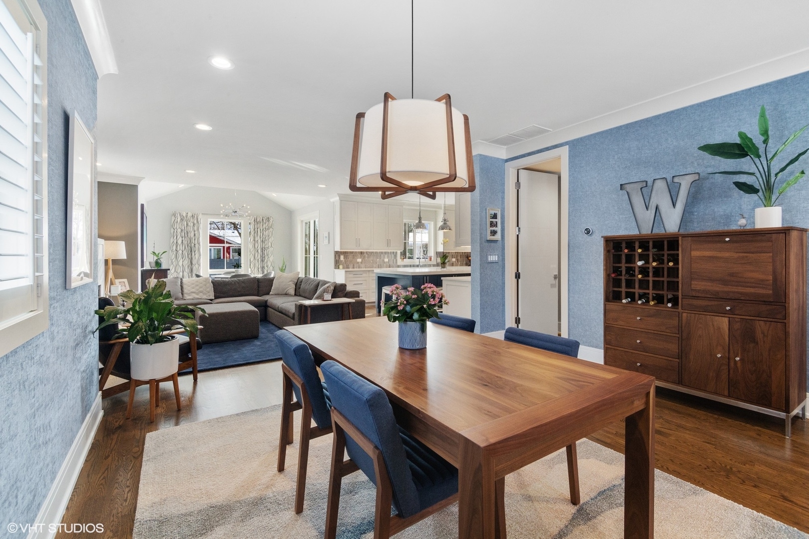 933 Echo Lane Glenview, IL 60025 - Photo 4 of 28 a dining room with furniture potted plants and wooden floor