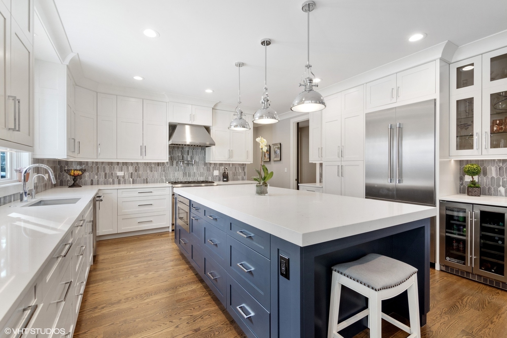 933 Echo Lane Glenview, IL 60025 - Photo 9 of 28 a large kitchen with kitchen island a island a sink a stove and chairs