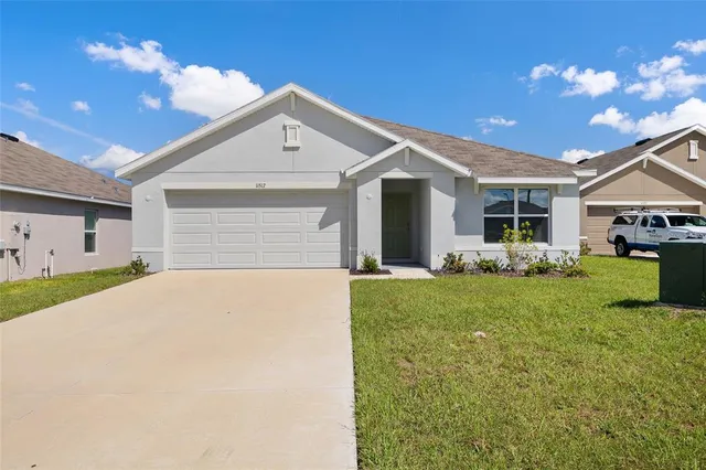 a front view of house with yard and outdoor seating