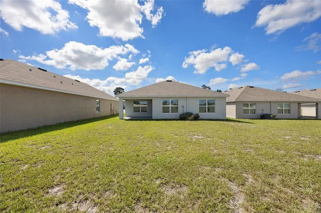a front view of a house with a big yard