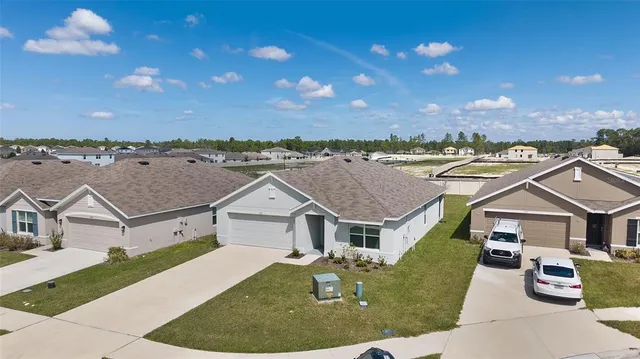 an aerial view of a house with a yard