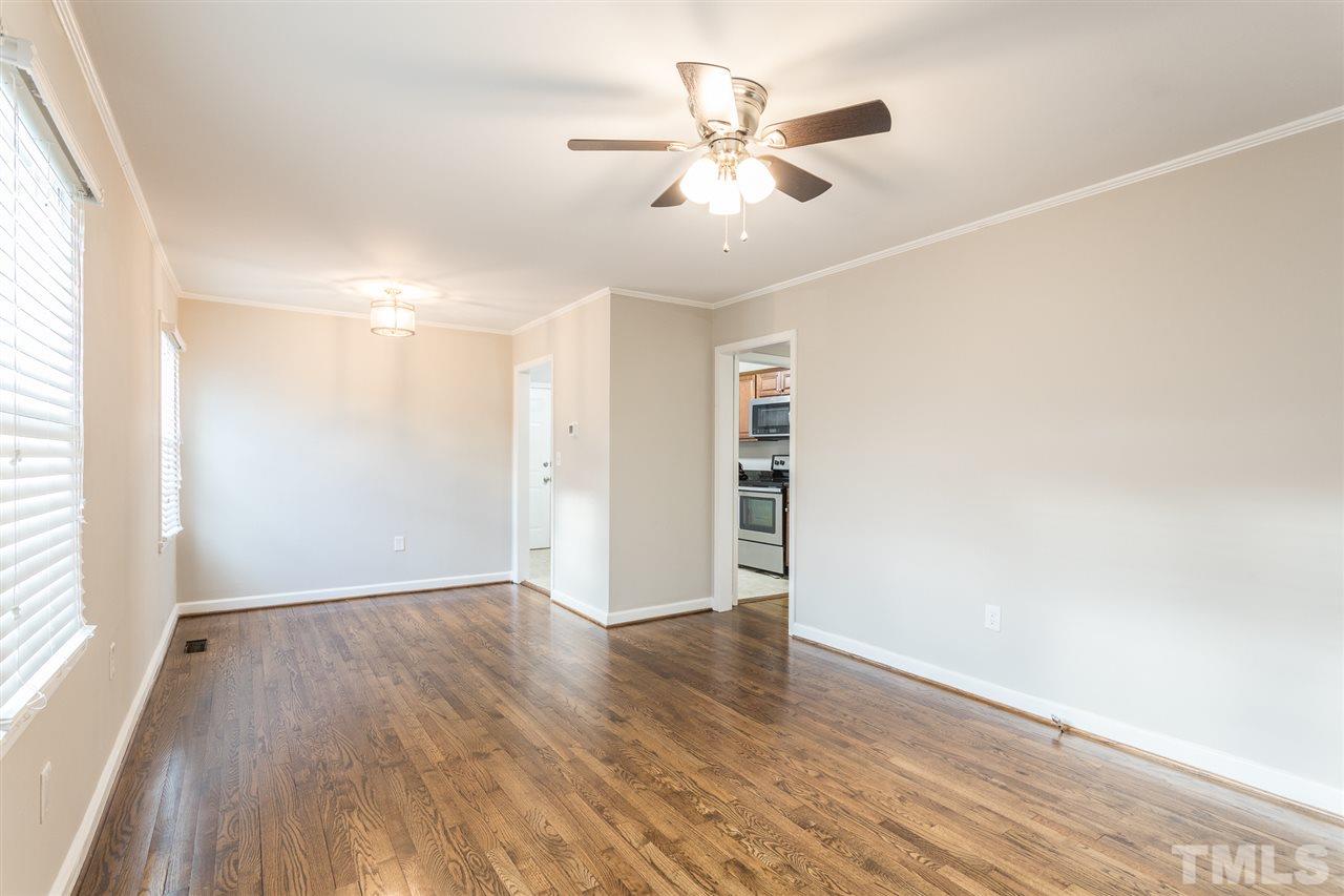 2732 Knowles Street Raleigh, NC 27603 - Photo 3 of 26 an empty room with wooden floor and windows