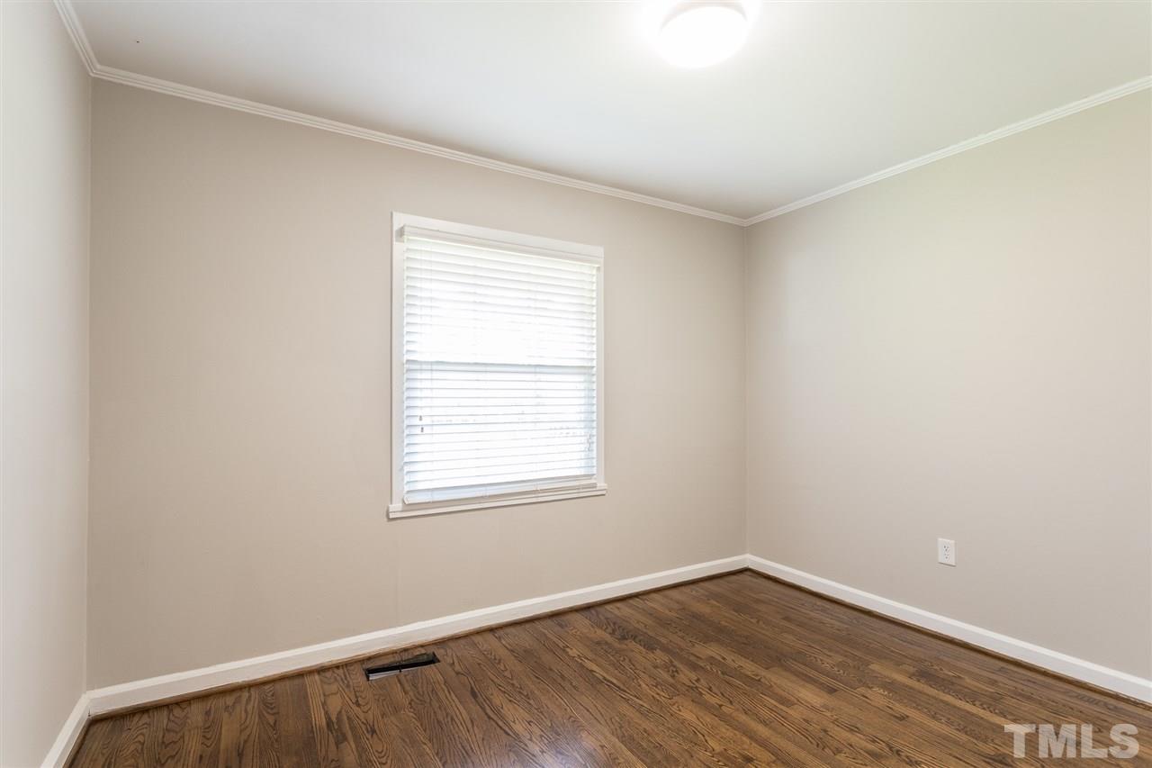 2732 Knowles Street Raleigh, NC 27603 - Photo 22 of 26 an empty room with wooden floor and windows