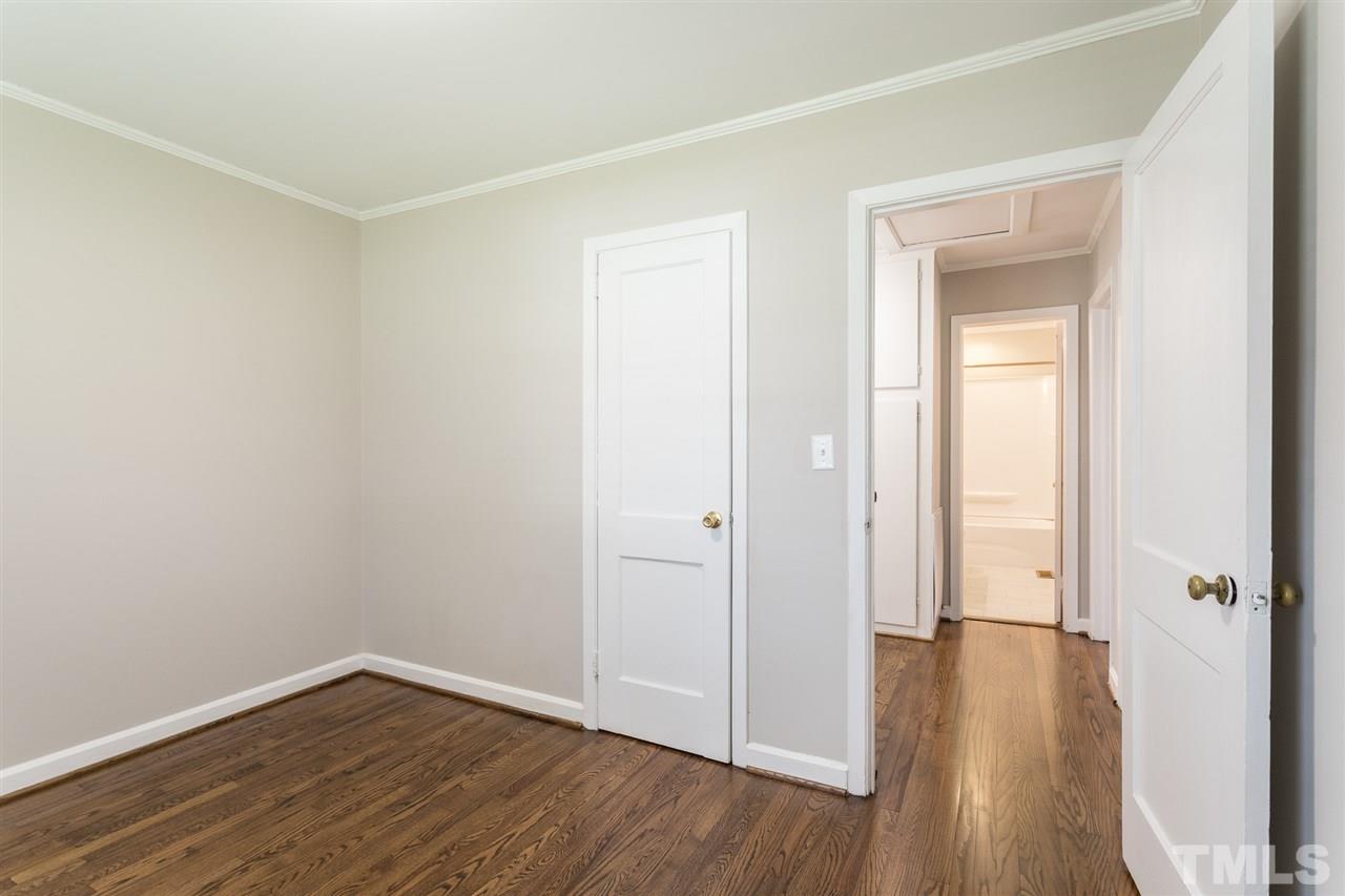 2732 Knowles Street Raleigh, NC 27603 - Photo 23 of 26 an empty room with wooden floor and a window