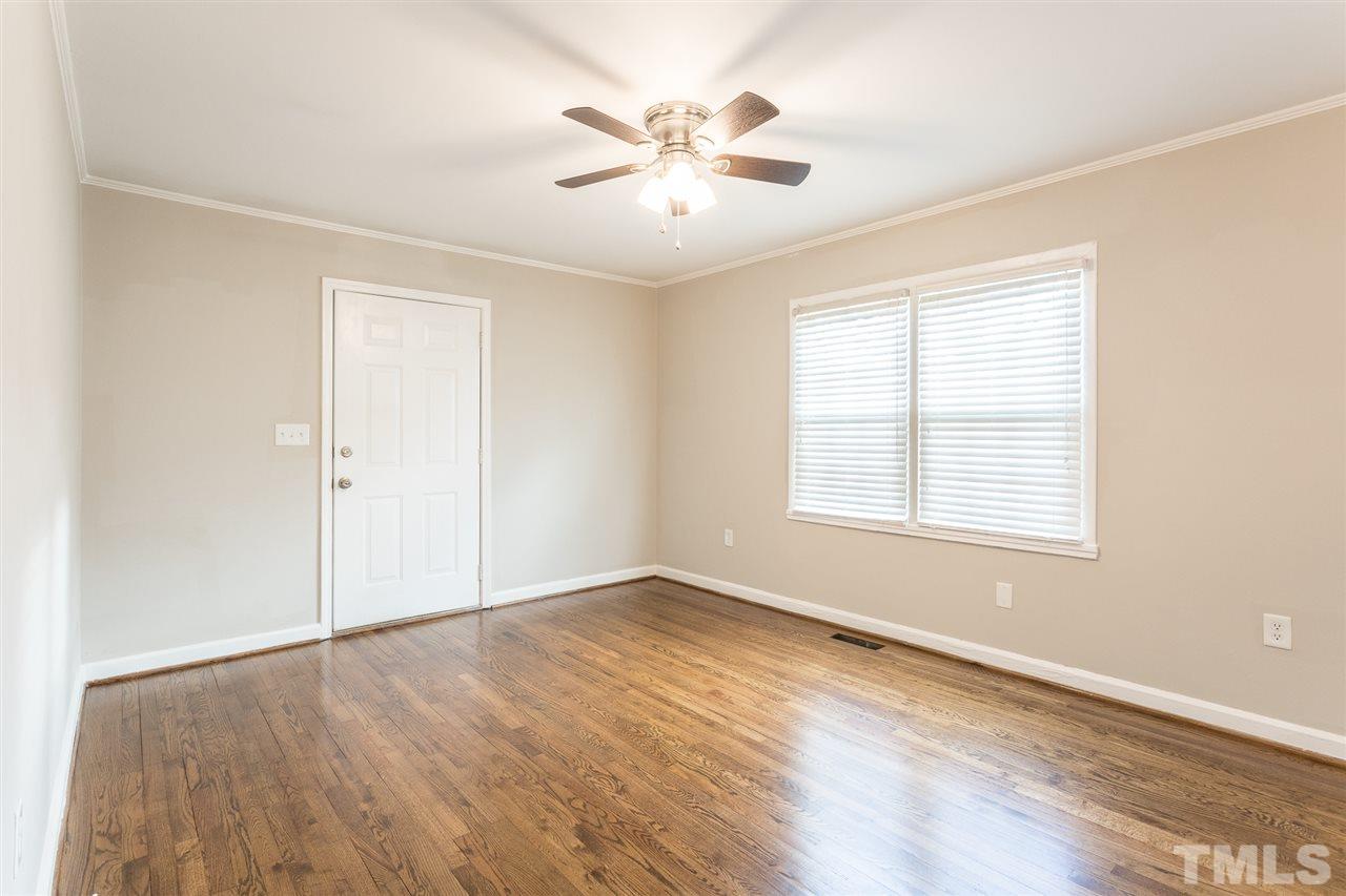 2732 Knowles Street Raleigh, NC 27603 - Photo 6 of 26 an empty room with wooden floor and windows