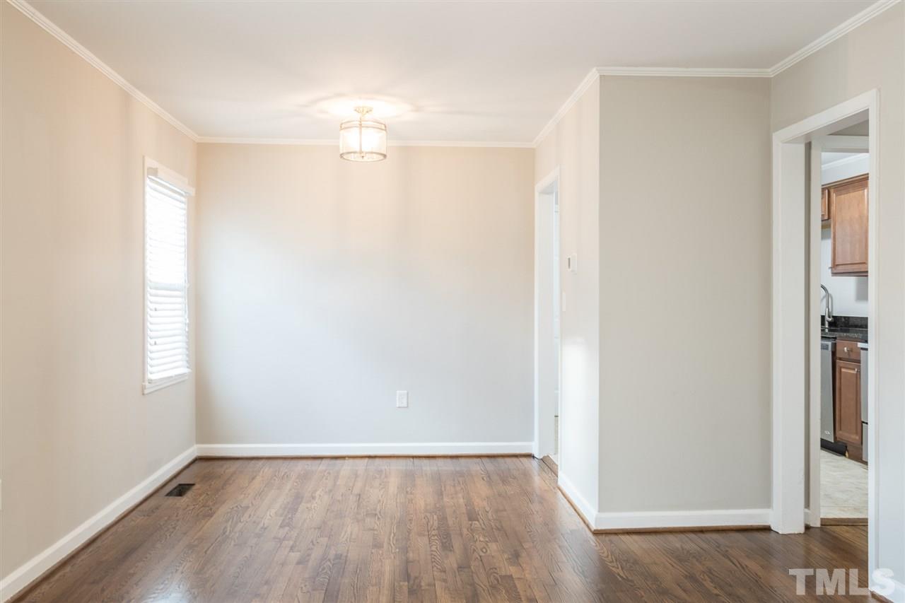 2732 Knowles Street Raleigh, NC 27603 - Photo 7 of 26 an empty room with wooden floor and windows